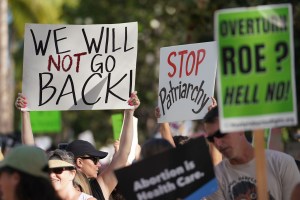 Demonstrators head up Kalakaua Avenue in a rally and march to defend the right to abortion.