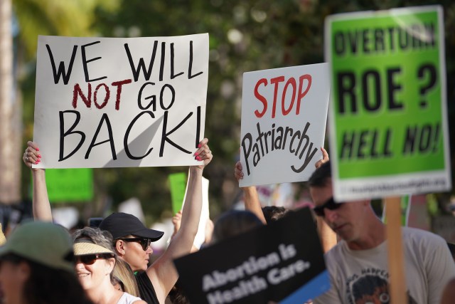 Demonstrators head up Kalakaua Avenue in a rally and march to defend the right to abortion.
