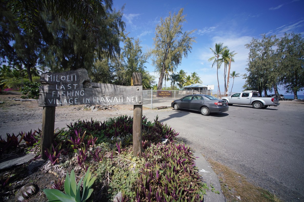 Milolii, Hawaii. View of the 'Last fishing village' sign near the parking lot.