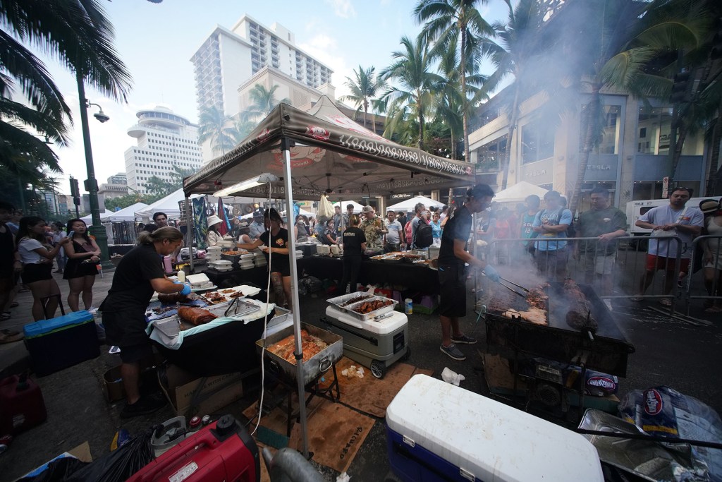 Block party vendor grills meats at the Leahi Festival held on Kalakaua Avenue.