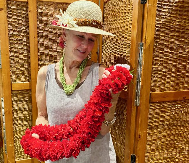 Vickie Fullard-Leo shows off the lei that her father, Dudley Fullard-Leo, brought to a memorial luncheon for Elizabeth “Tita” Marks Stack.