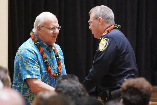 HPD Honolulu Police Chief Joe Logan is greeted by Mayor Rick Blangiardi after being sworn in at the Mission Memorial Auditorium.