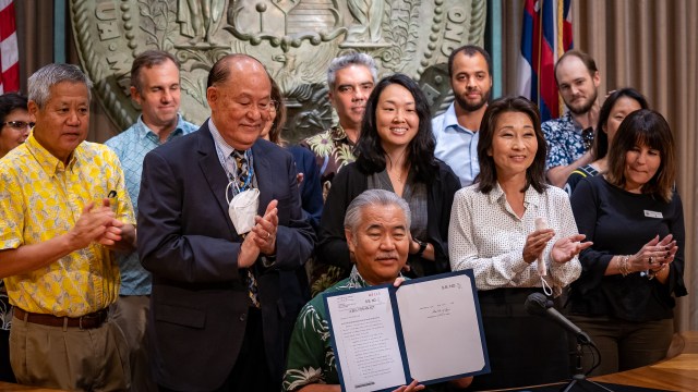 Gov. David Ige signed the minimum wage increase, the tax refund and the EITC bills into law at the Hawaii State Capitol's ceremonial room on Wednesday.