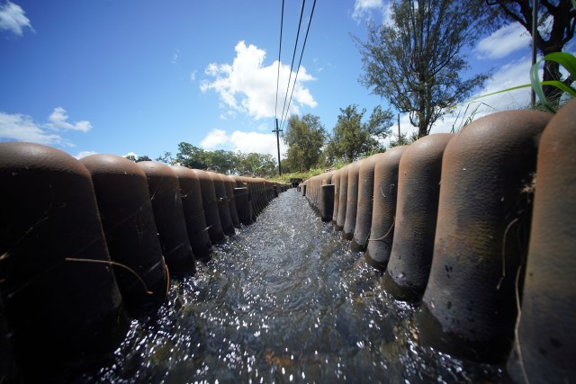 Water flows near a reservoir located along Kaukonahua Road near Wailua, Oahu.