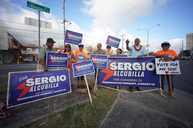 Sergio Alcubilla supporters gather and hold signs along South King Street and Beretania Street.