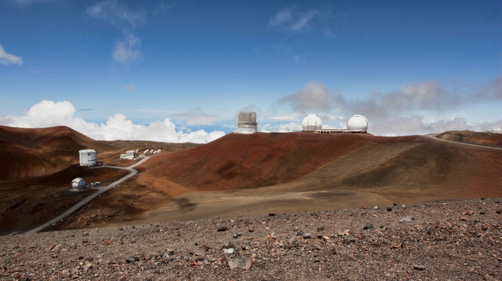 FILE - Telescopes are seen on the summit of Mauna Kea on Hawaii's Big Island, on Aug. 31, 2015. The National Science Foundation said Tuesday, July 19, 2022,  that it plans to conduct a study to evaluate the environmental effects of building the Thirty Meter Telescope, one of the world's largest optical telescopes, on sites selected on Mauna Kea in Hawaii and Spain's Canary Islands. (AP Photo/Caleb Jones, File)