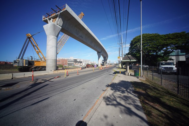HART Rail guideway as it nears the OCCC Oahu Community Correctional Center and moves towards metro Honolulu. The bridge connects the bus transit center to the rail via the pedestrian bridge.