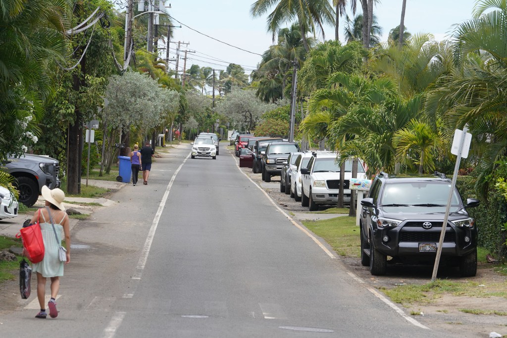 Cars parked along Lanikai's Mokulua Drive.