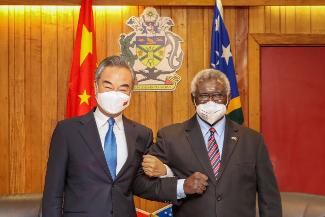FILE - In this photo released by Xinhua News Agency, Solomon Islands Prime Minister Manasseh Sogavare, right, locks arms with visiting Chinese Foreign Minister Wang Yi in Honiara, Solomon Islands on May 26, 2022. A U.S. coast guard cutter conducting patrols as part of an international mission to prevent illegal fishing was recently unable to get clearance for a scheduled port call in the Solomon Islands, according to reports, an incident that comes amid growing concerns of Chinese influence on the Pacific nation. (Xinhua via AP, File)