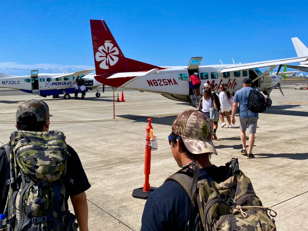 Passengers board a Mokulele Airlines flight on Oahu that's headed to Molokai.