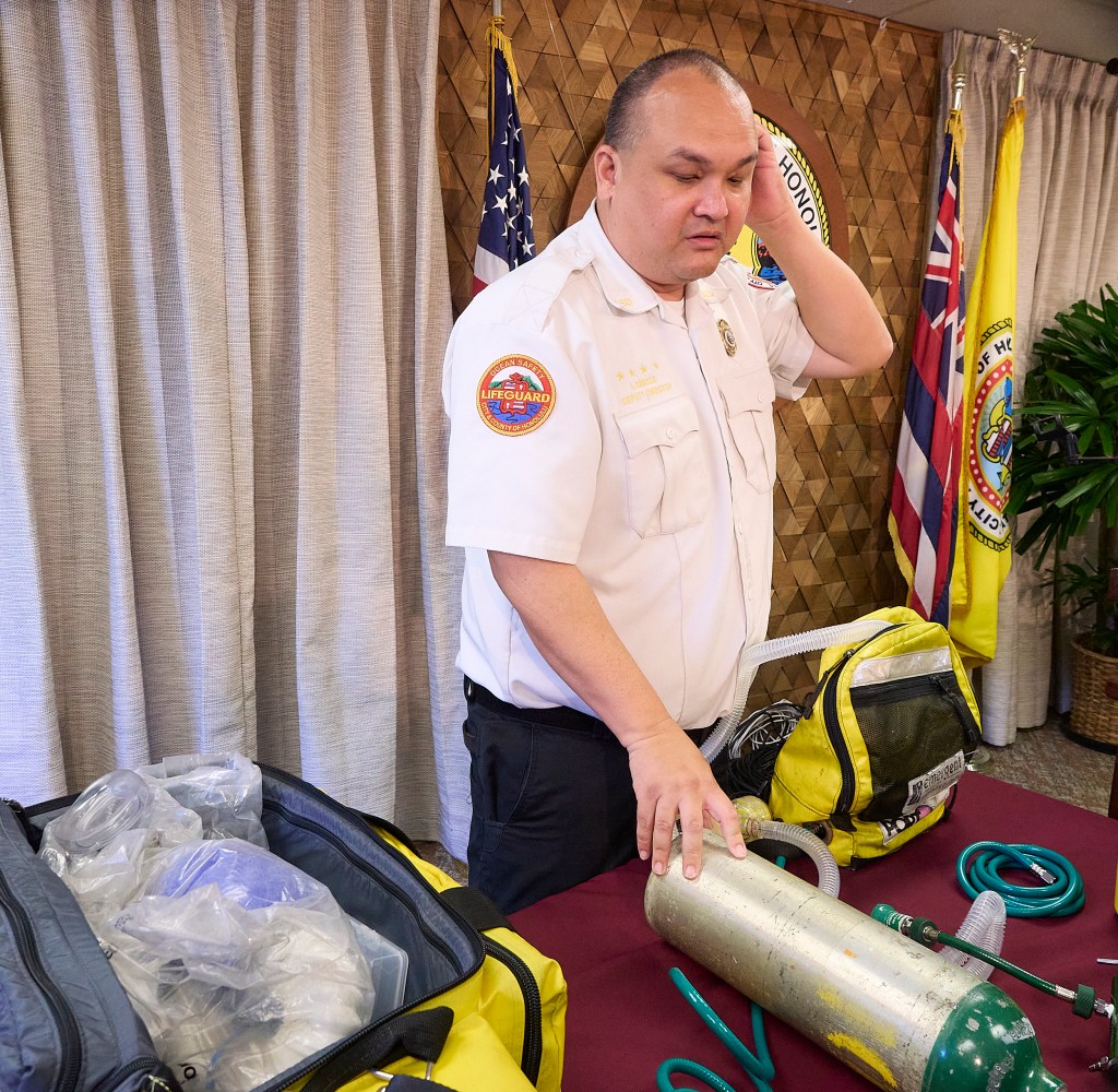 Ocean Safety Lifeguard Deputy Director Ian Santee portable container oxygen that is moved with a patient as they are transported from the Ambulance into the Hospital