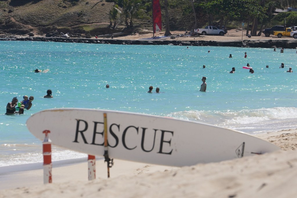 Kailua Beach Ocean safety surfboard with swimmers enjoying the beach.
