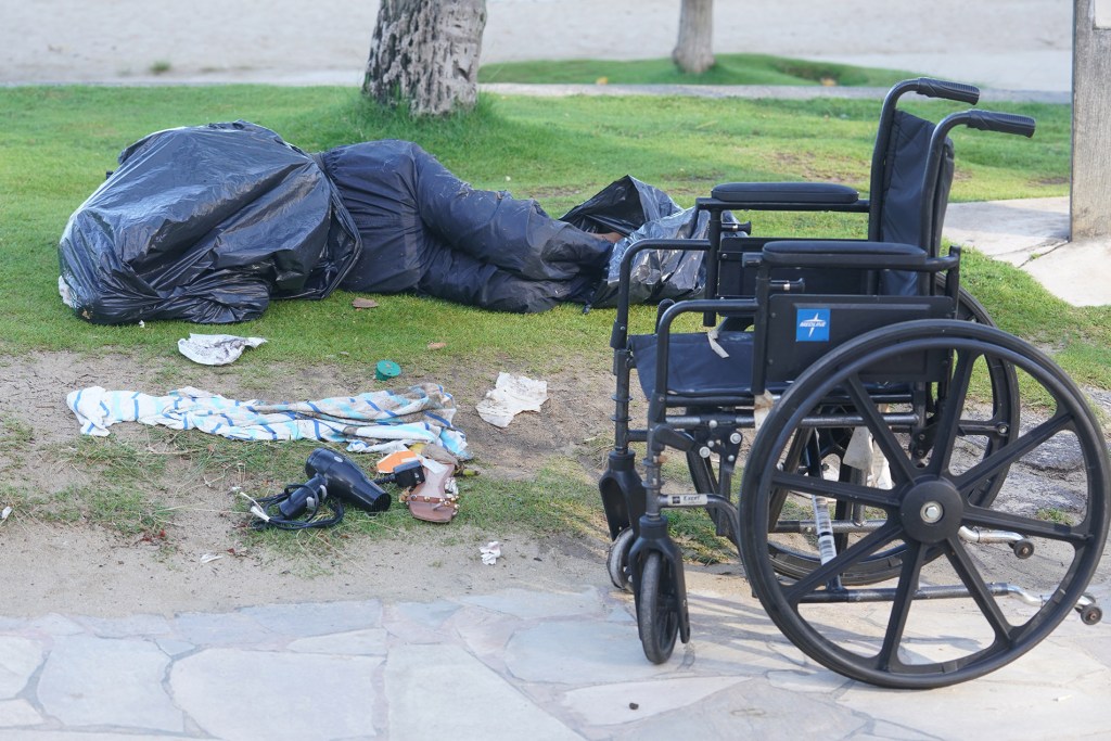 Sleeping person wrapped in garbage bags along Kalakaua Avenue the day after the Safe Sound Waikiki program press conference was held with lawmakers and local Waikiki business leaders.