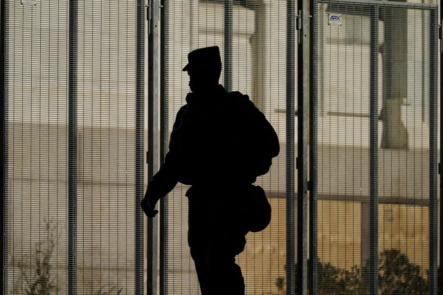 FILE - A National Guard soldier walks past a barricade as security is ramped ahead of President-elect Joe Biden's inauguration ceremony Jan. 18, 2021, in Washington. Soldiers are leaving the Army National Guard at a faster rate than they are enlisting, fueling concerns that in the coming years units around the country may not meet military requirements for overseas and other deployments. Officials say the number of soldiers retiring or leaving the Guard each month in the past year has exceeded those coming in, for a total annual loss of about 7,500 service members. (AP Photo/Matt Slocum, File)