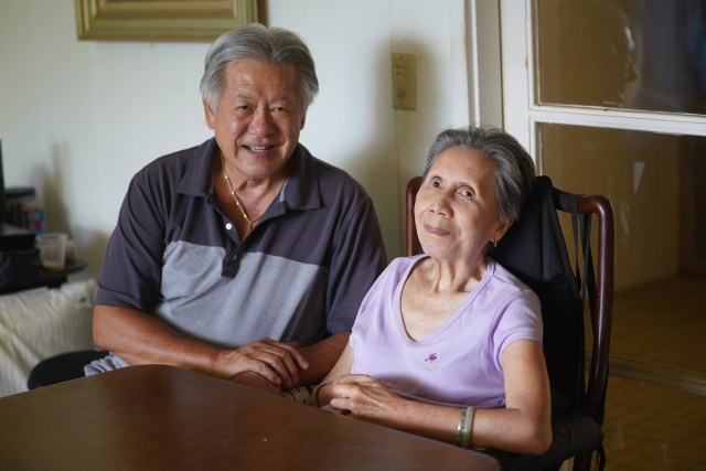 Portrait of homeowner Clayton Chang and his wife Maureen Chang with breakfast in their living space/living room. Chang has cleared out most of his rooms after a major flood damaged his home. Chang has been waiting years to get a DPP permit to demolish and rebuild.