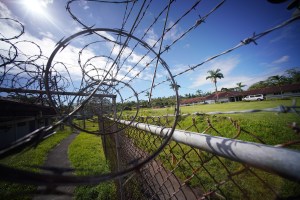 Hale Nani jail prison located on Hawaii island. View of the mens area on right thru razor wire located on the separate womens prison building.