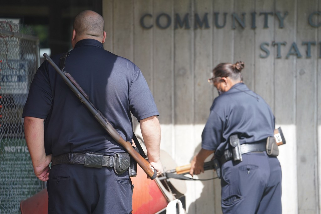 Guards carry shotguns at the entrance of Hawaii Community Correctional Center due to construction blocking their normal entrance.