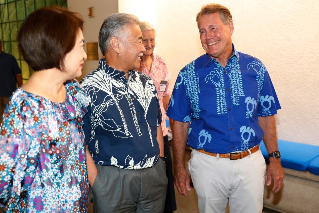 Dawn Ige, left, Hawaii Gov. David Ige and Rep Ed Case, right, D-Hawaii, speak at a Democratic gathering on election night Tuesday, Nov. 8, 2022, in Honolulu. (AP Photo/Marco Garcia)