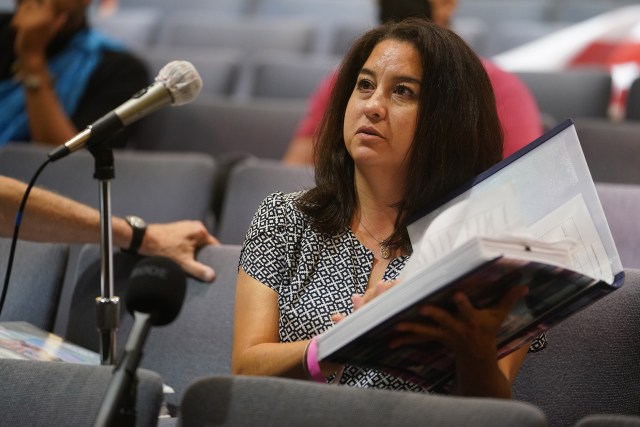 Lacey Quintero holds her album with 6-pages of medical reports during her testimony during the Department of Health Fuel Tank Advisory Committee Meeting held at the Capitol Auditorium.