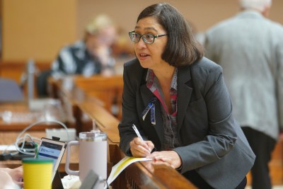 Honolulu City Council member Esther Kiaaina speaks to staff before meeting.