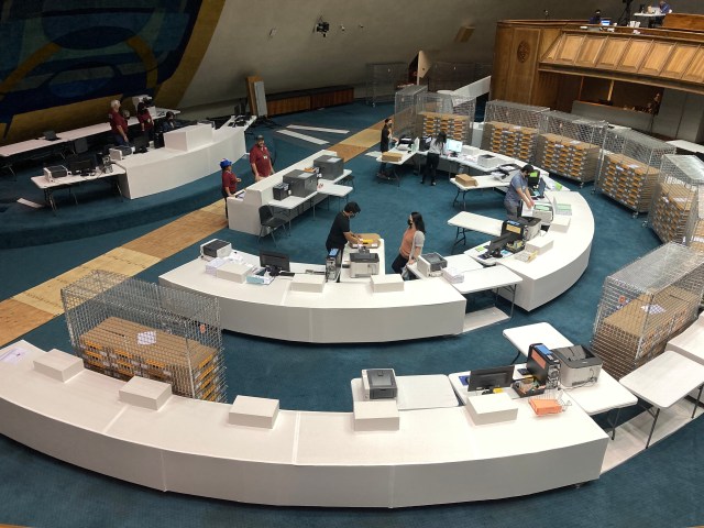 overhead view of the senate chamber, where volunteers and officials are tabulating the ballots