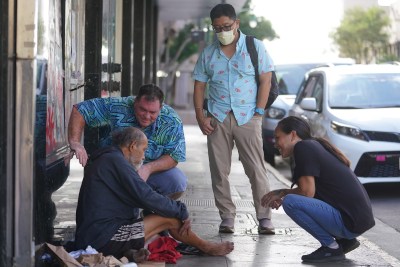 IHS Outreach Navigation Program Coordinator David Warman, Dr. Chad Koyanagi and right, IHS Assistant Outreach Navigation Program Coordinator Shona Cobb stop to assist a man that said he felt sick and needed help.