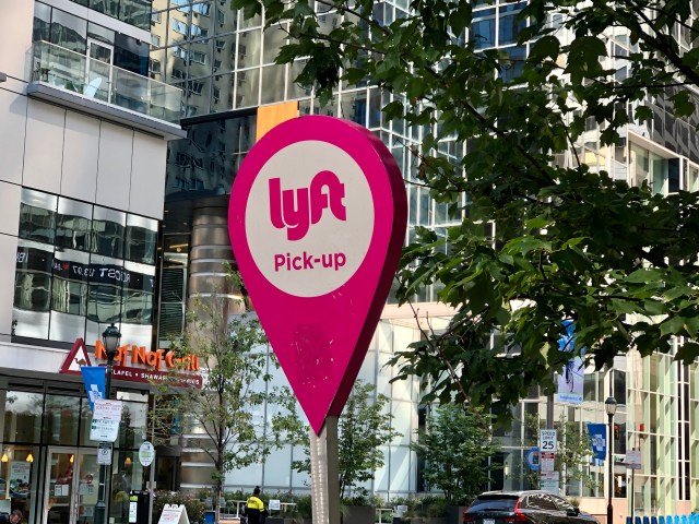 Philadelphia, Pennsylvania United States - August 31 2021: Lyft mobile app ride sharing sign for a pickup station with bus.