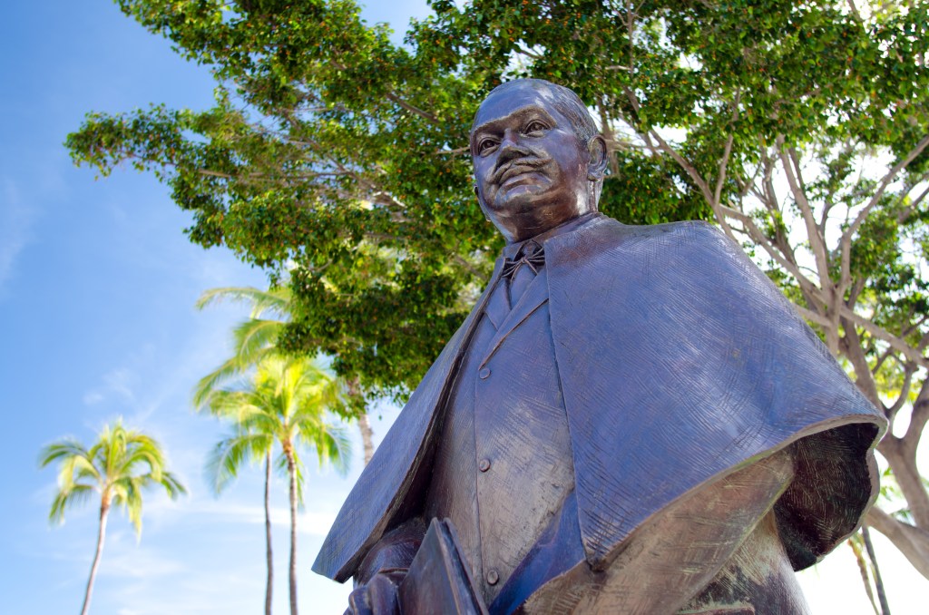 Honolulu, United States - April 22, 2011: The Prince Kuhio Statue along Waikiki beach, sculpted by Sean K.L. Browne and dedicated in 2002.