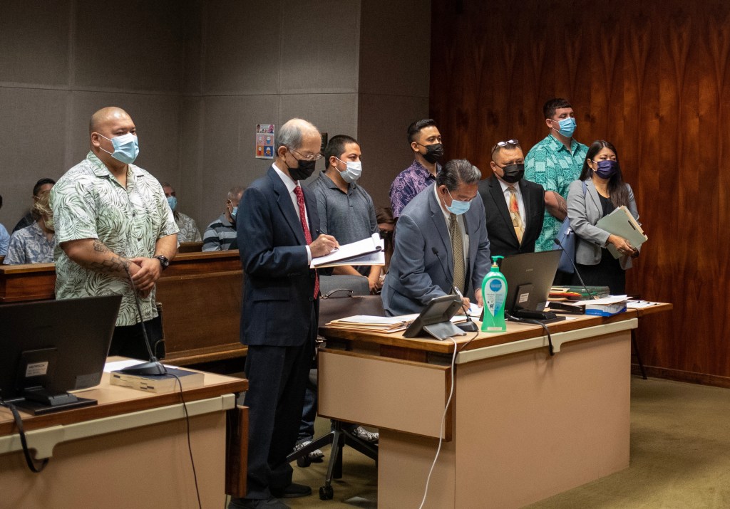 2023 March 23 CTY - Pool Photo by Cindy Ellen Russell. Honolulu Police Department police officers (back, L-R) Joshua Nahalu, Robert G. Lewis III, Jake R.T. Bartolome and Erik X.K. Smith make their initial court appearance with their attorneys (front, L-R) Howard Luke, Benjamin Ignacio, Pedric Arrisgado and Doris Lum. The four Honolulu police officers face felony charges in connection with a September 2021 police pursuit that ended in a crash that the officers allegedly fled and conspired to cover up. The officers plead not guilty.