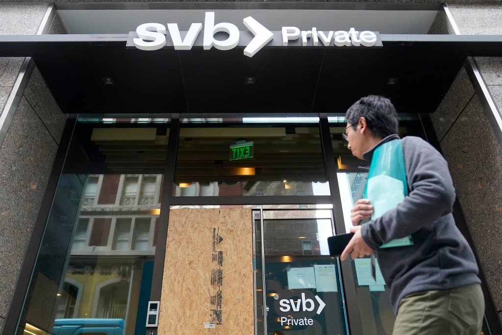 A pedestrian passes a Silicon Valley Bank branch in San Francisco, Monday, March 13, 2023. As the primary regulator of the bank, the Federal Reserve is coming under sharp criticism from financial watchdogs and banking experts. (AP Photo/Jeff Chiu)