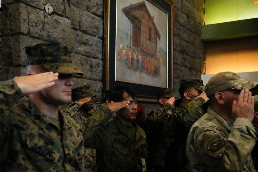 Filipino and U.S. troops salute during opening ceremonies for the joint military exercise flag called "Balikatan," a Tagalog word for "shoulder-to-shoulder," at Camp Aguinaldo military headquarters Tuesday, April 11, 2023, in Quezon City, Philippines. The United States and the Philippines on Tuesday launch their largest combat exercises in decades that will involve live-fire drills, including a boat-sinking rocket assault in waters across the South China Sea and the Taiwan Strait that will likely inflame China. (AP Photo/Aaron Favila)