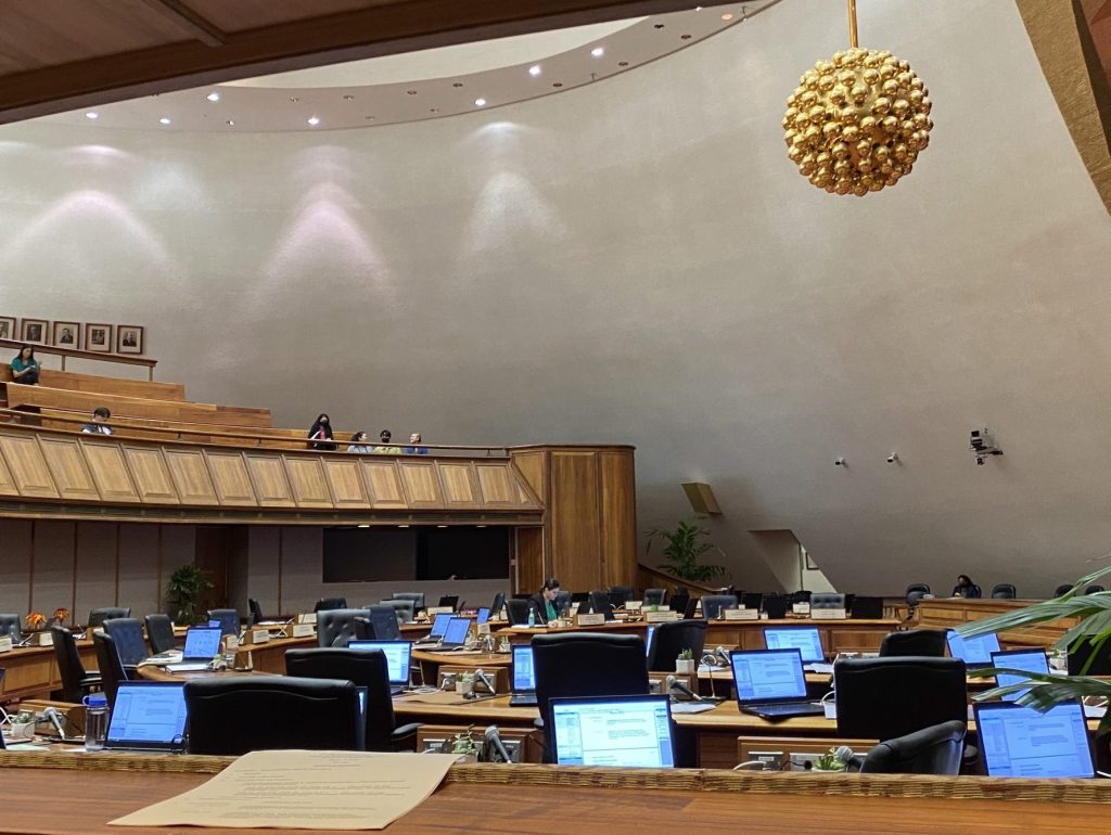 Woman sits alone in the House chamber