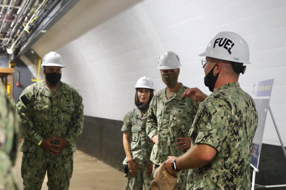 Navy. Lt. Cmdr. Shannon Bencs, NAVSUP Fleet Logistics Pearl Harbor fuels director for Red Hill, pictured center back