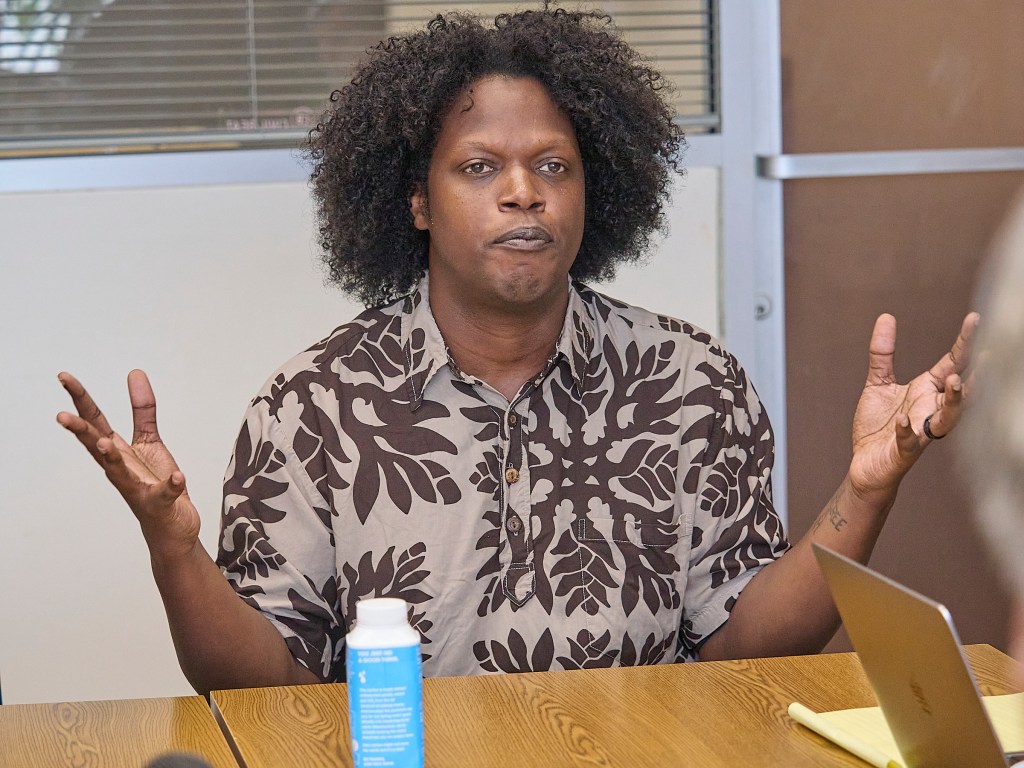 Camron Hurt, Common Cause Hawaii's new Program Director dominates the image as he discusses elements of a free society with Civil Beat's Editorial Board