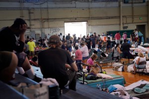The food line at the War Memorial Gymnasium grows at lunch time for those displaced by the wildfires photographed on Thursday, Aug. 10, 2023, in Kahului. (Kevin Fujii/Civil Beat/2023)
