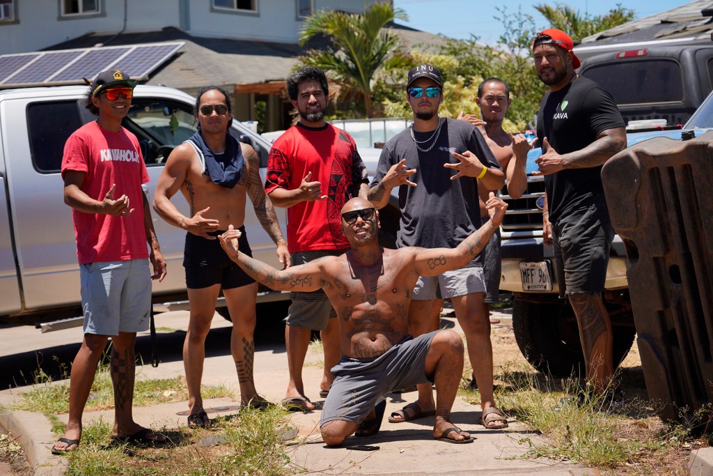 Despite the tragedy, residents gather together to help the neighborhood and pose for a photo Sunday, Aug. 13, 2023, north of Lahaina town and south of Kaanapali. A large fire consumed areas of West Maui last week. Utilities have not been fully restored. (Kevin Fujii/Civil Beat/2023)