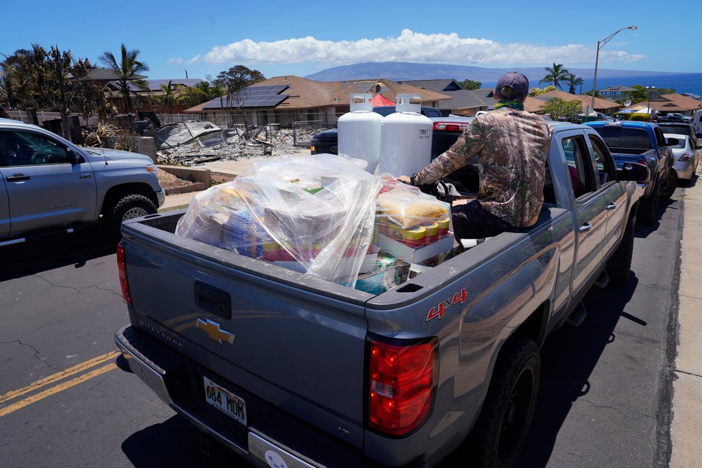 Supplies to help those affected by the wildfires are distributed Sunday, Aug. 13, 2023, in Wahikuli neighborhood, north of Lahaina town and south of Kaanapali. A large fire consumed areas of West Maui last week. Utilities have not been fully restored. (Kevin Fujii/Civil Beat/2023)