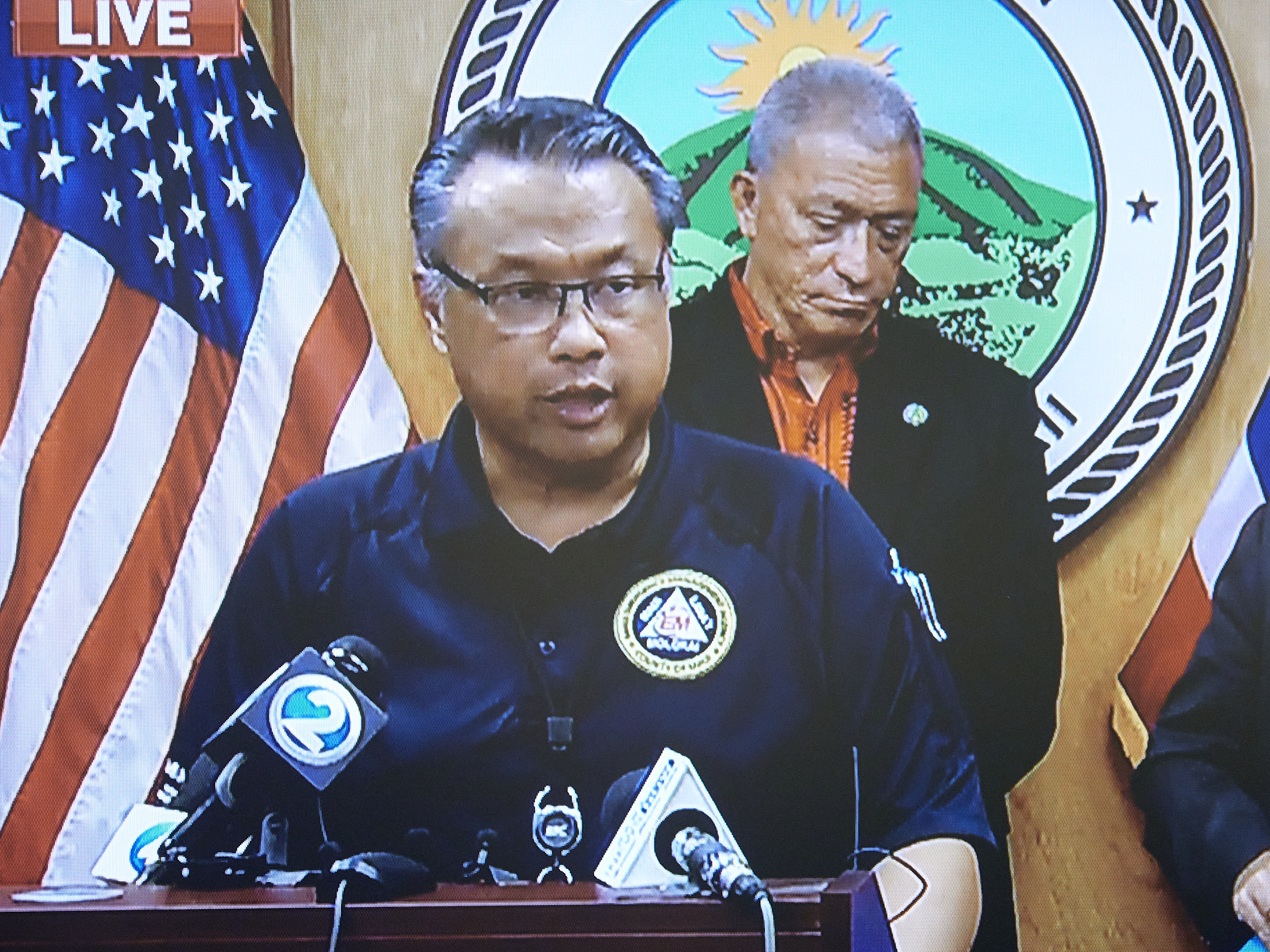 Herman Andaya stands at the podium in the Mayors conference room in Wailuku