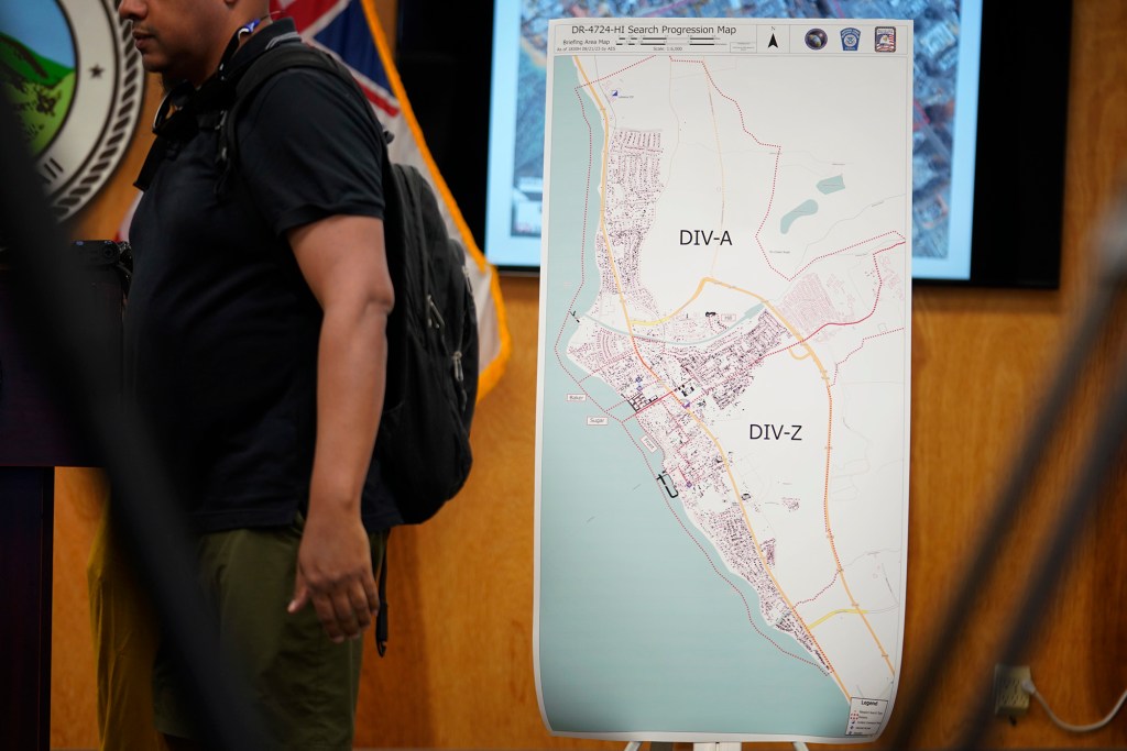 A map showing each building and area searched in Lahaina is seen before a press conference Tuesday, Aug. 22, 2023, in Wailuku. The gathering was to share information on those missing and the process to identify remains found in the Aug. 8 Lahaina wildfire. (Kevin Fujii/Civil Beat/2023)
