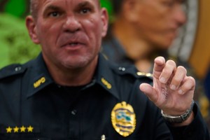 Numbers and a word are written on Maui Police Chief John Pelletier’s palm during a press conference Tuesday, Aug. 22, 2023, in Wailuku. The gathering was to share information on those missing and the process to identify remains found in the Aug. 8 Lahaina wildfire. (Kevin Fujii/Civil Beat/2023)