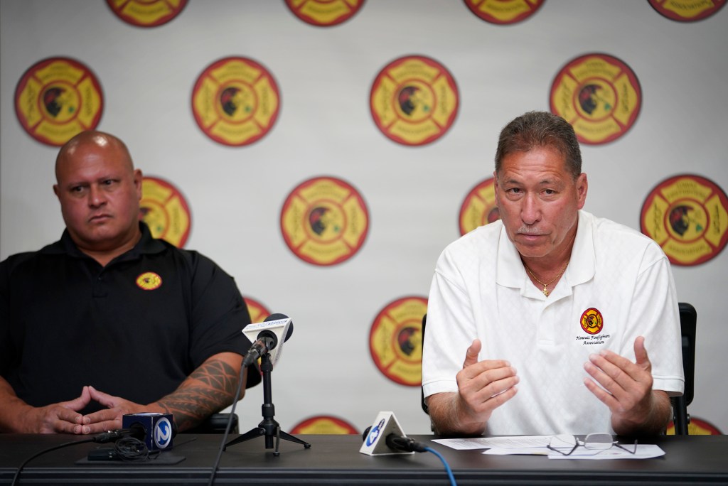 Hawaii Fire Fighters Association Local 1463 secretary treasurer Aaron Lenchanko, from left, and president Bobby Lee speak during a press conference Wednesday, Aug. 23, 2023, in Honolulu. California Fire Foundation, EmergencyRV and Los Angeles County Fire Fighters Local 1014 donated five RV (recreation vehicle) trailer homes to Maui firefighters who lost their homes in the Aug. 8 Lahaina wildfire. (Kevin Fujii/Civil Beat/2023)
