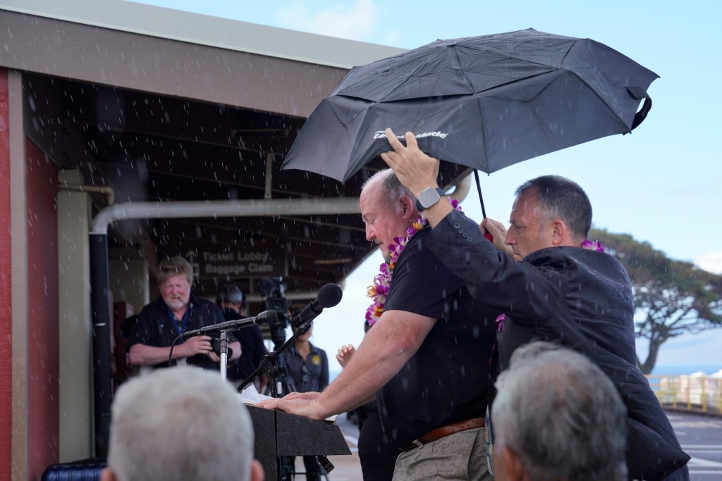 Gov. Josh Green has Bob Fenton’s back while he addresses the media about the Federal Emergency Management Agency’s participation to reopen schools in West Maui on Tuesday, Sept. 26, 2023, at Kapalua Airport in Lahaina. Fenton is the chief federal response coordinator for FEMA, The Army Corps of Engineers will be building a temporary replacement school for King Kamehameha III Elementary. (Kevin Fujii/Civil Beat/2023)