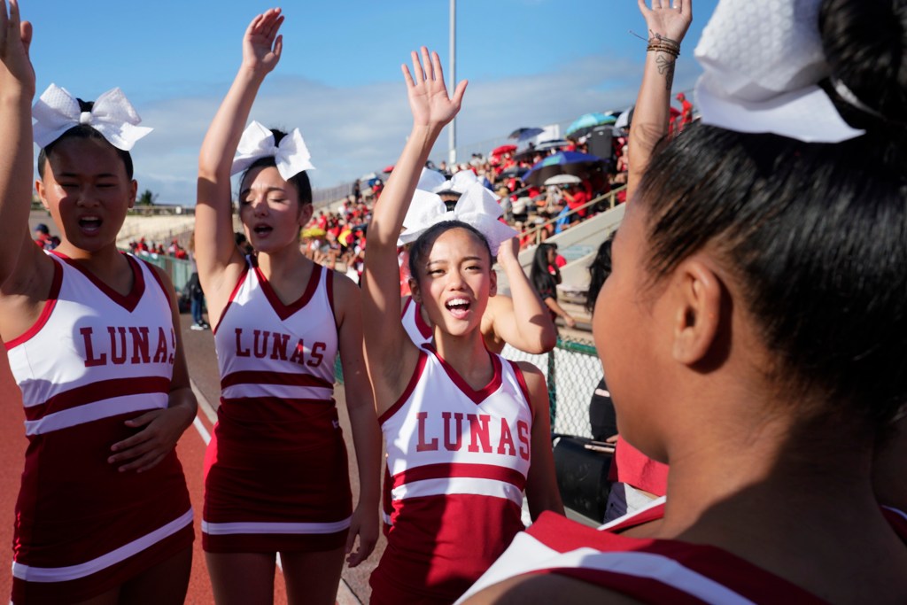 Lahainaluna High School cheerleader Michelle Arzaga, a junior, leads the squad’s pre-game cheer before their first football game Saturday, Sept. 30, 2023, at War Memorial Stadium in Wailuku. The sold-out game paves the little way slowly back to normalcy after the devastating Aug. 8 fire. (Kevin Fujii/Civil Beat/2023)