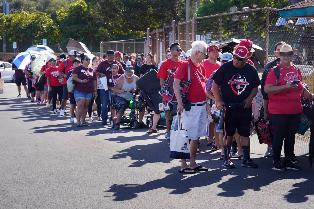 Fans, supporters, students and Lahaina community members line up for the first football game of the season for Lahainaluna High School Saturday, Sept. 30, 2023, at War Memorial Stadium in Wailuku. The sold-out game paves the little way slowly back to normalcy after the devastating Aug. 8 fire. (Kevin Fujii/Civil Beat/2023)
