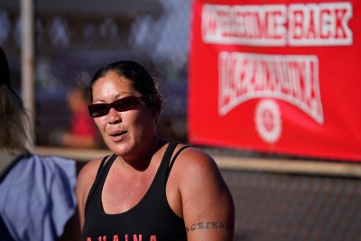Felicia Johnson-Mckenzie of Makali’i Printing sells goods supporting Lahainaluna High School before the team’s first football game Saturday, Sept. 30, 2023, at War Memorial Stadium in Wailuku. The sold-out game paves the little way slowly back to normalcy after the devastating Aug. 8 fire. (Kevin Fujii/Civil Beat/2023)