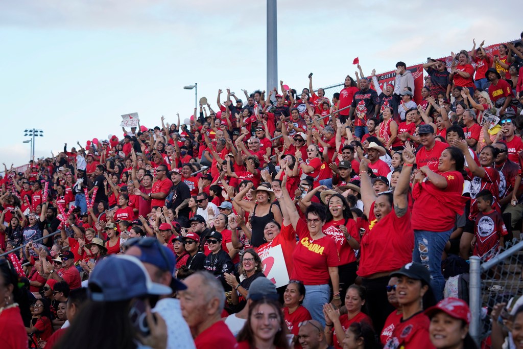 Lahainaluna High School fans celebrate a touchdown during the junior varsity game against Baldwin High School Saturday, Sept. 30, 2023, at War Memorial Stadium in Wailuku. The sold-out game paves the little way slowly back to normalcy after the devastating Aug. 8 fire. (Kevin Fujii/Civil Beat/2023)