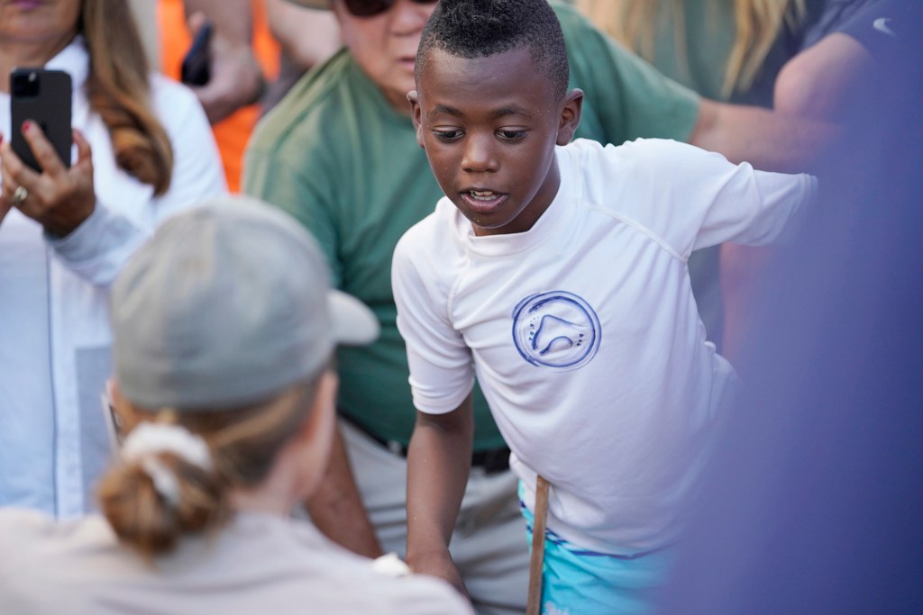 Everest Jackson, 8 of Phoenix, is mesmerized by the honu eggshell Monday, Oct. 2, 2023, at Sandy Beach in Honolulu. Everest and his family are spending his fall break in Hawaii. He takes home an unforgettable experience to tell his classmates about. (Kevin Fujii/Civil Beat/2023)