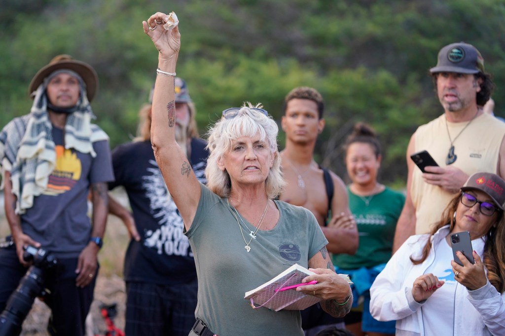 Malama I No Honu volunteer Debbie Herrera holds up an empty green sea turtle eggshell Monday, Oct. 2, 2023, at Sandy Beach in Honolulu. A crowd of about 80 people came to see the honu hatchlings release. (Kevin Fujii/Civil Beat/2023)