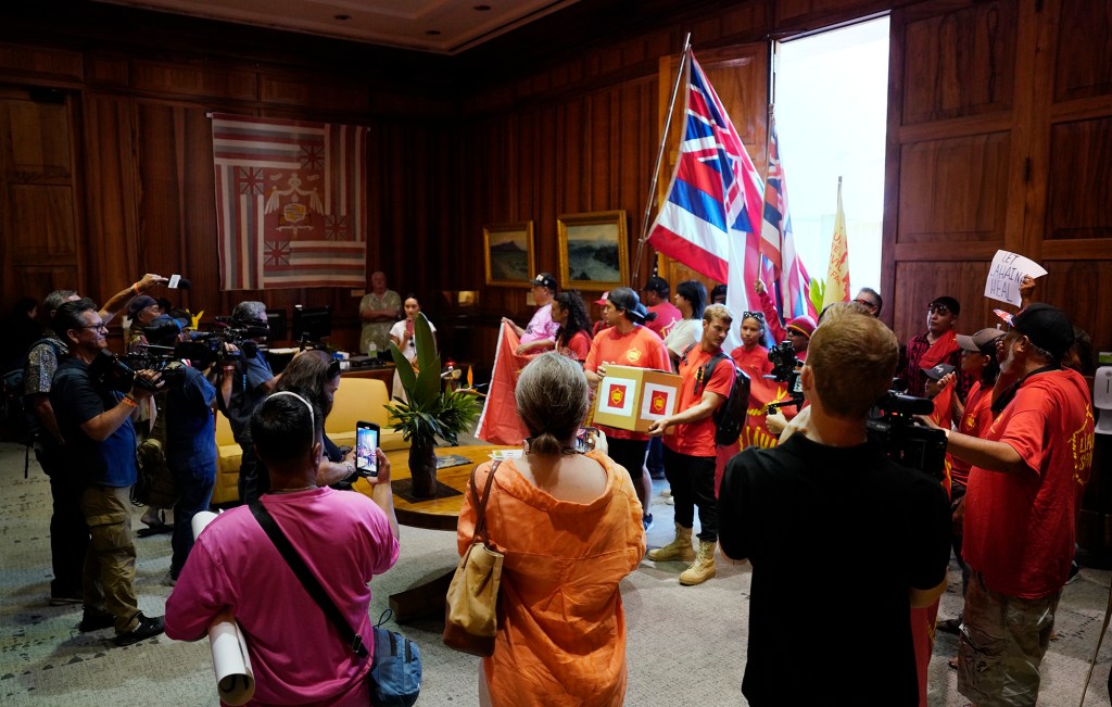 Lahaina Strong community members and the media fill  Gov. Josh Green’s office Tuesday, Oct. 3, 2023, in Honolulu. Residents of Lahaina and Maui-wide delivered a petition to keep tourism to West Maui closed until they’re ready host tourists after the Aug. 8 fire destroyed Lahaina town. (Kevin Fujii/Civil Beat/2023)