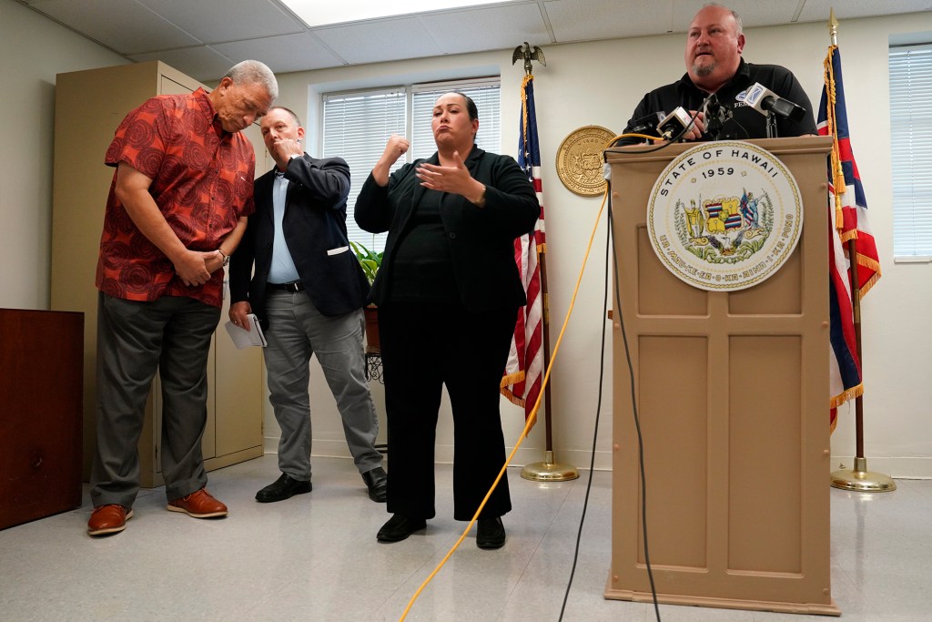 Maui County Mayor Richard Bissen, from left, listens to Gov. Josh Green as ASL interpreter and FEMA’s Bob Fenton give a press conference Wednesday, Oct. 18, 2023, in Wailuku. Federal, state and county governments gave updates on progress after the Aug. 8 fire which destroyed Lahaina town and Kula area. (Kevin Fujii/Civil Beat/2023)